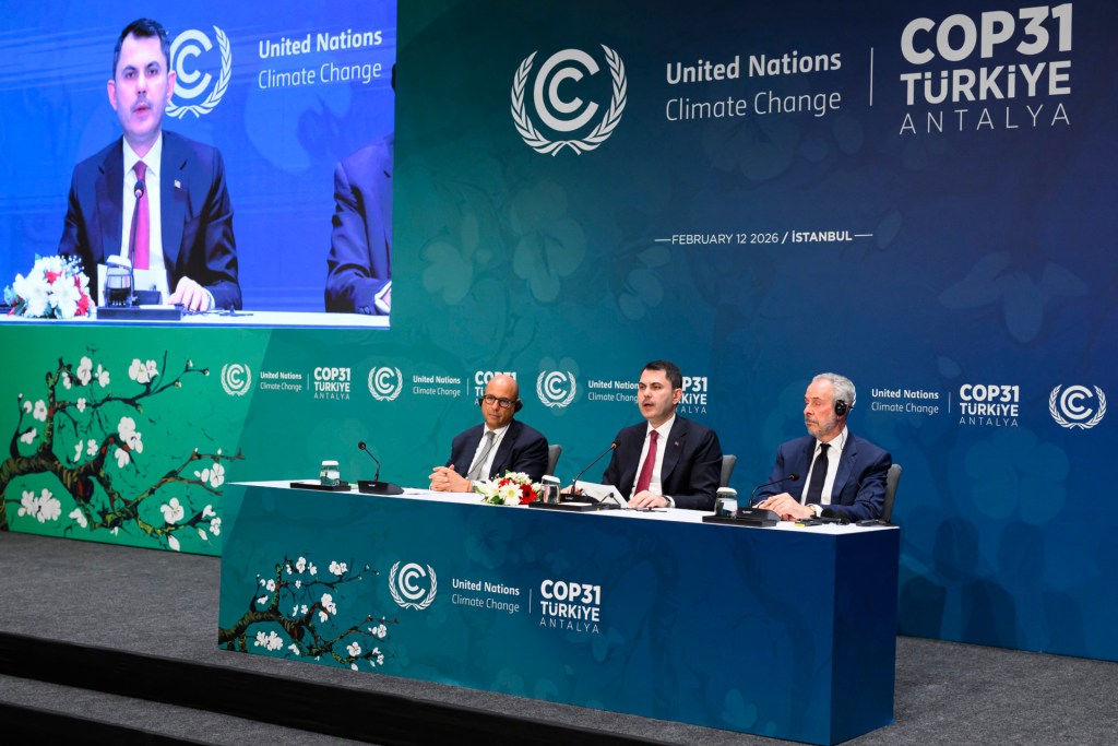 Turkey's Minister of Environment, Urbanization and Climate Change Murat Kurum (C) speaks next to United Nations Climate Change Executive Secretary Simon Stiell (L) and COP30 President Andre Correa do Lago (R) during a conference in Istanbul on February 12, 2026, ahead of United Nations's COP31 climate conference in November.